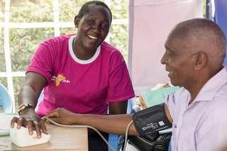 Man with healthcare worker in Kenya